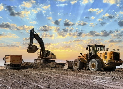 Excavator pushing dirt at a construction site.