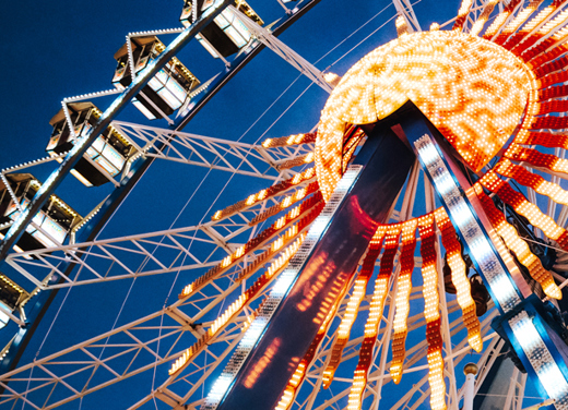 Lit up ferris wheel at twilight.