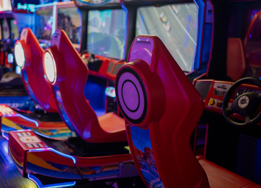 Rows of arcade driving games.
